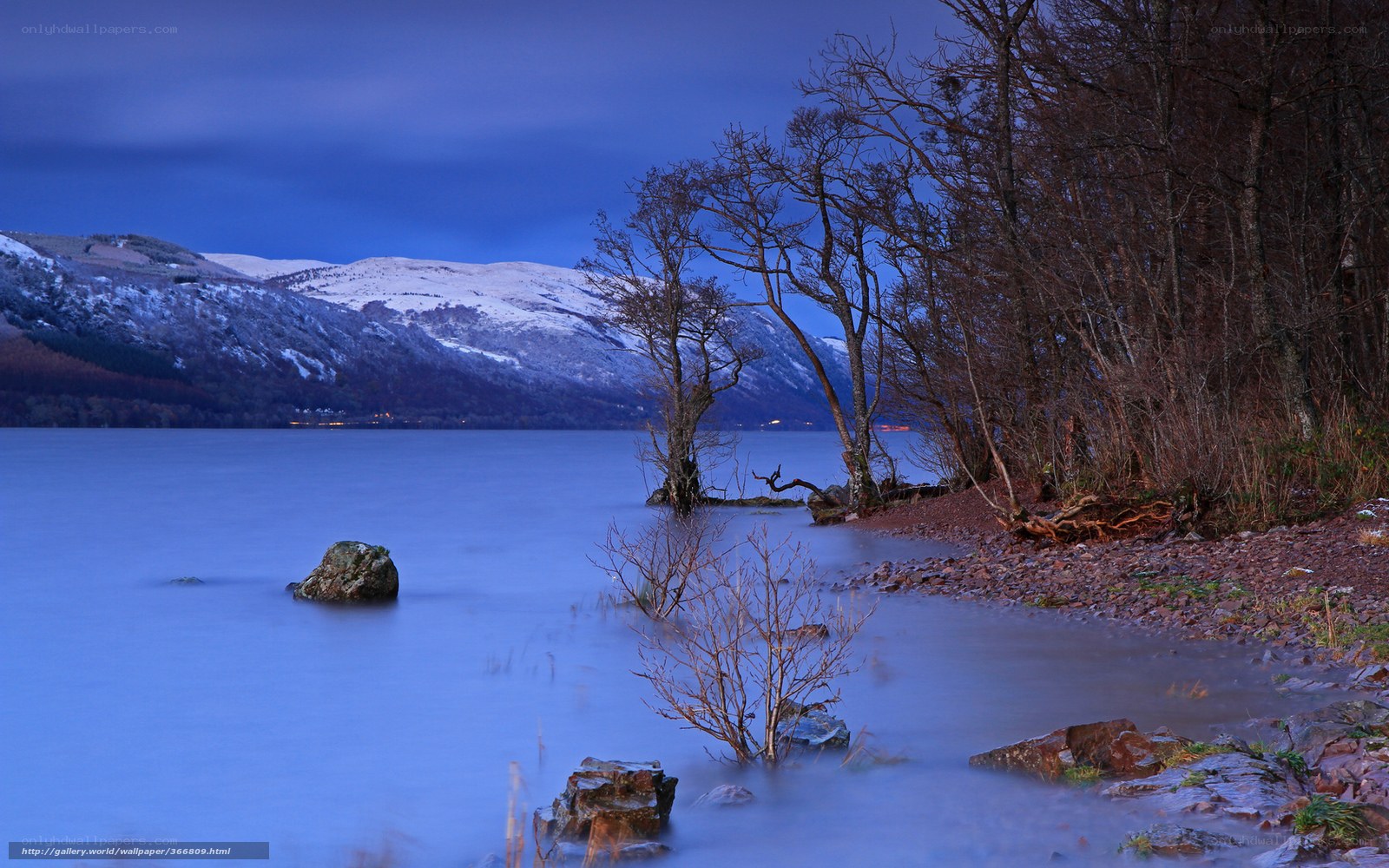 Snowy mountains by a lake