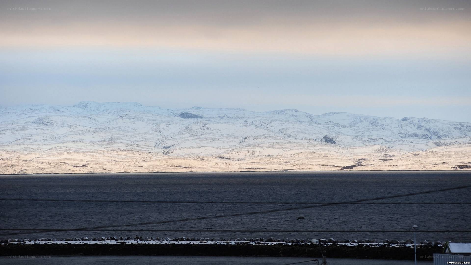 Snowy mountains by the sea