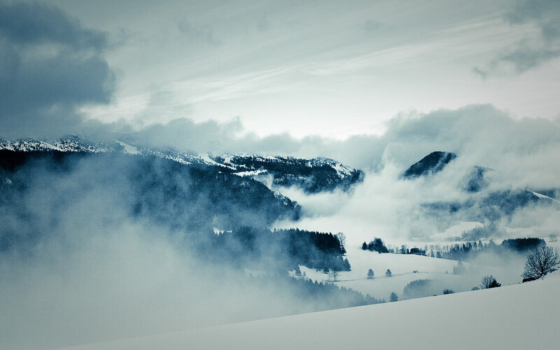 Snowy mountains in fog