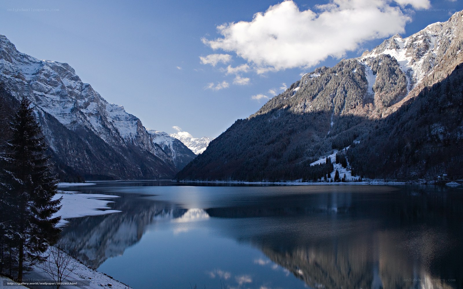 Snowy mountains reflect in lake
