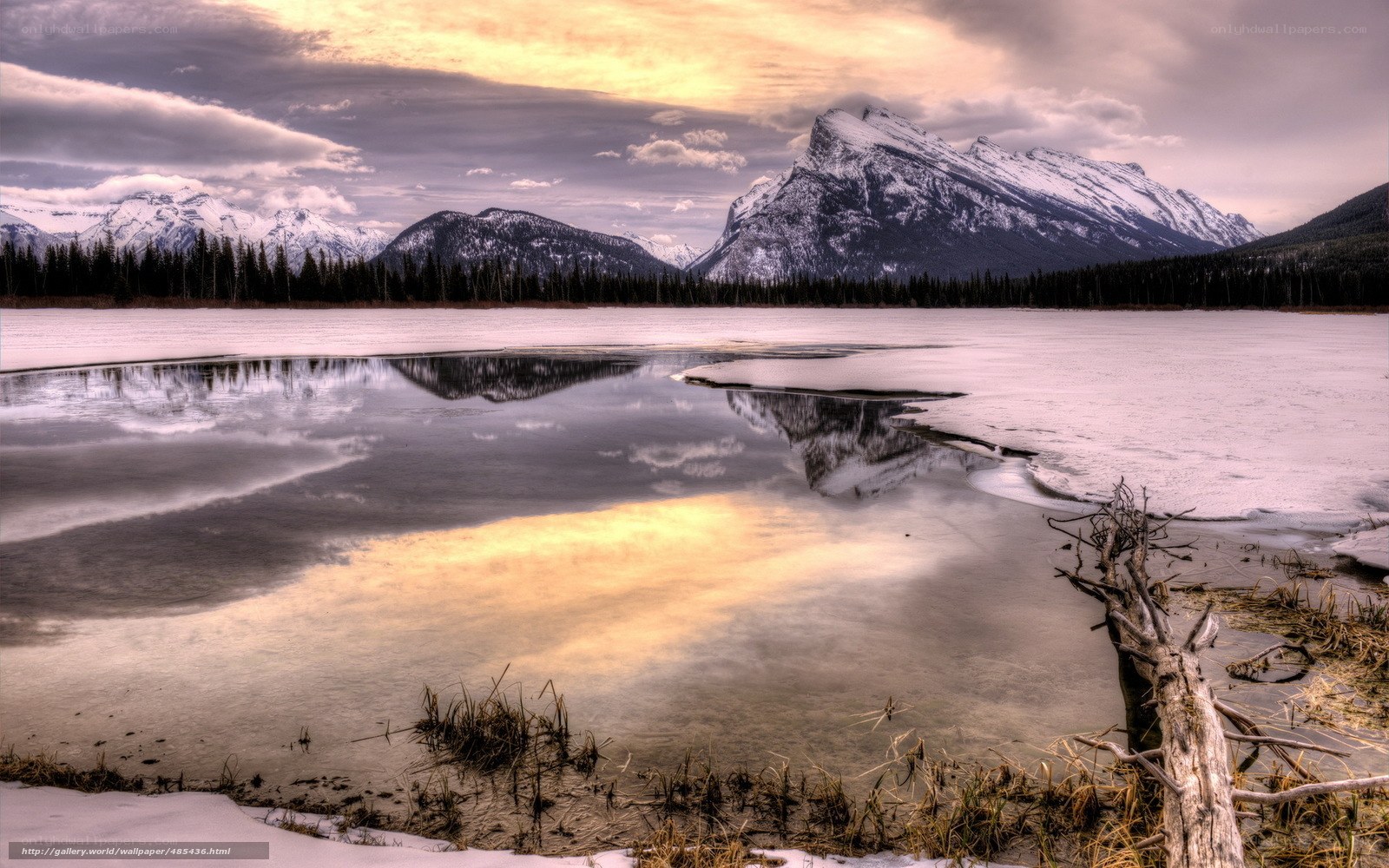 Snowy mountains reflect in lake