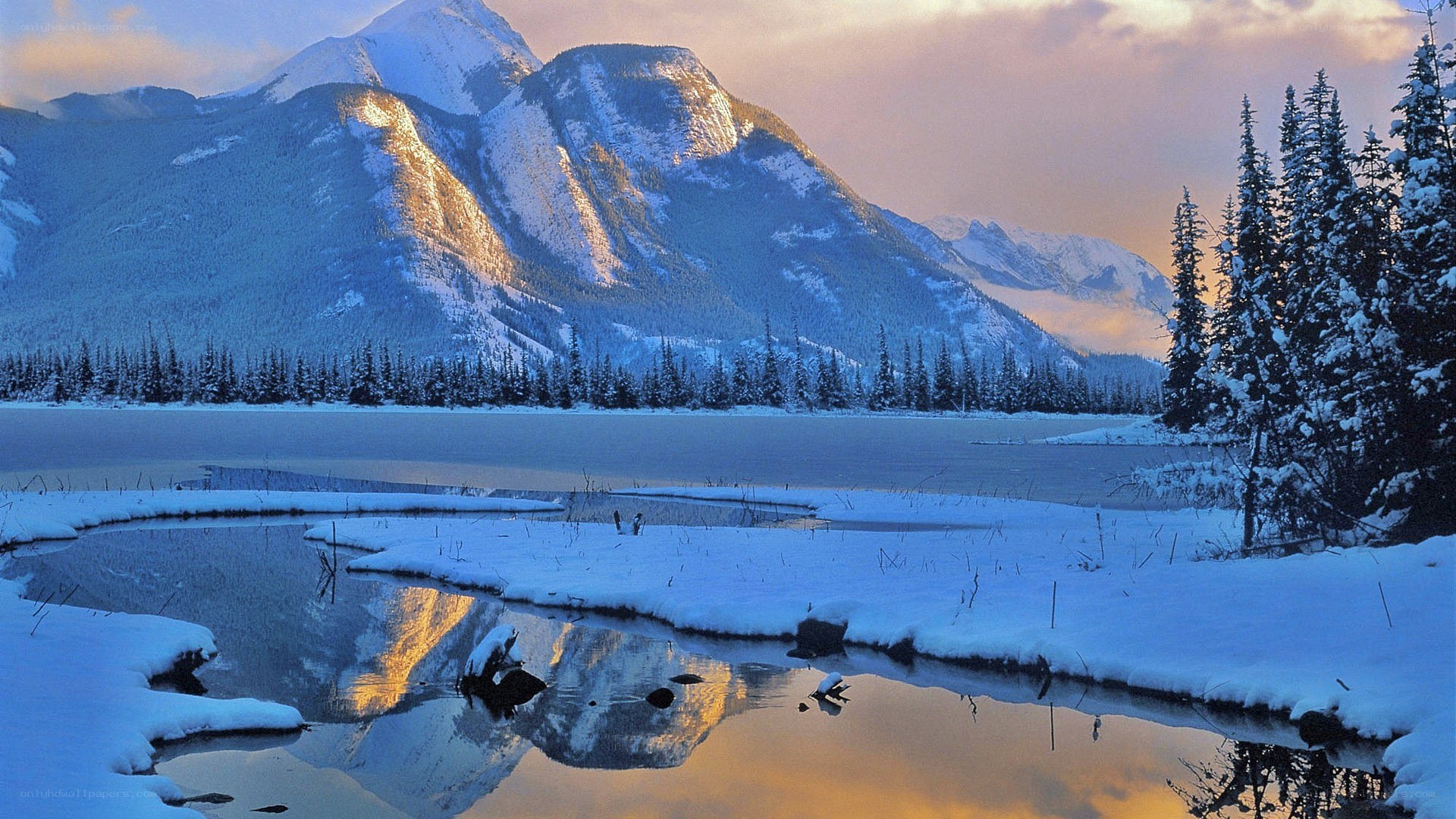 Snowy mountains reflected in a lake