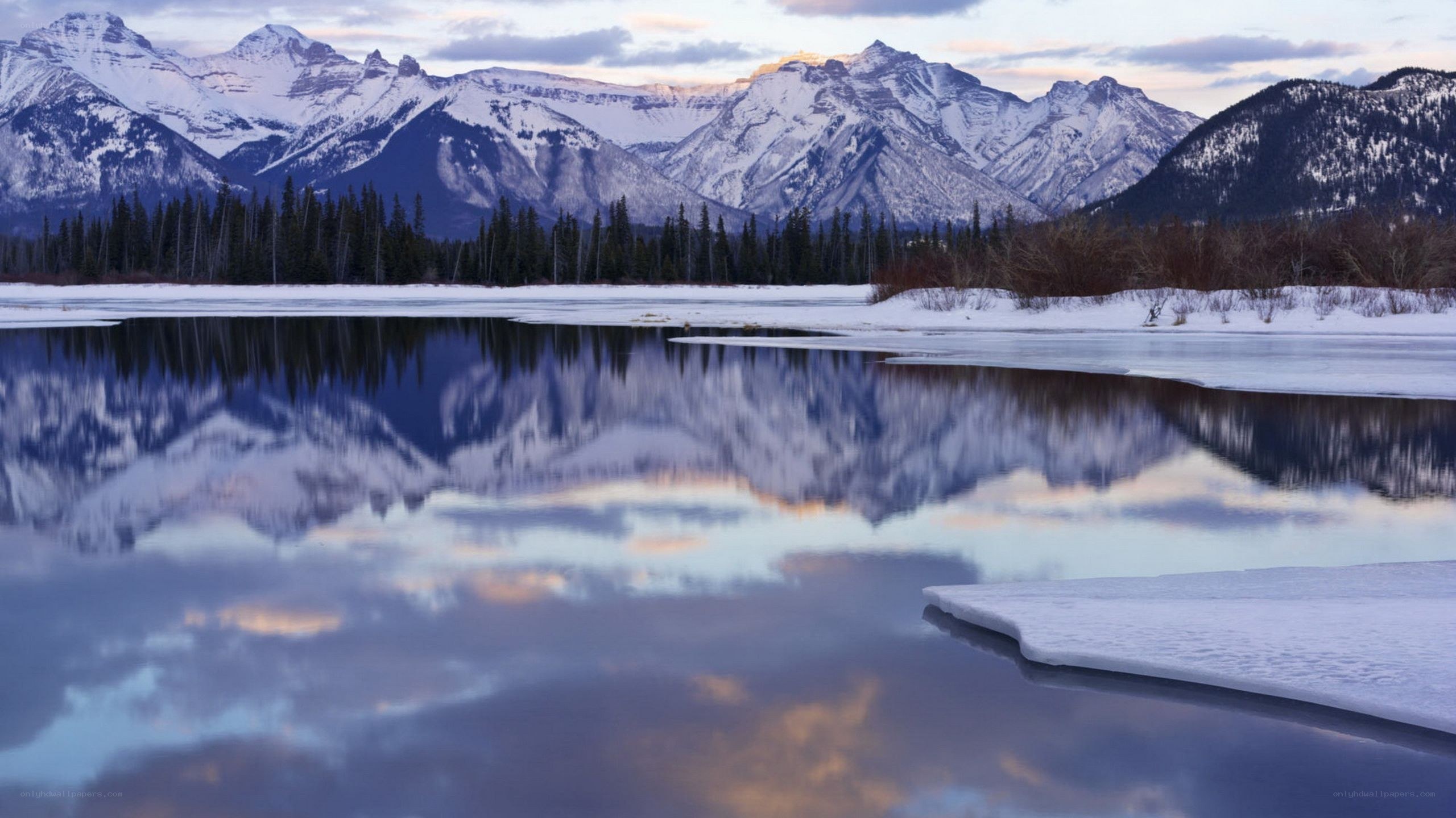 snowy mountains reflected in a lake