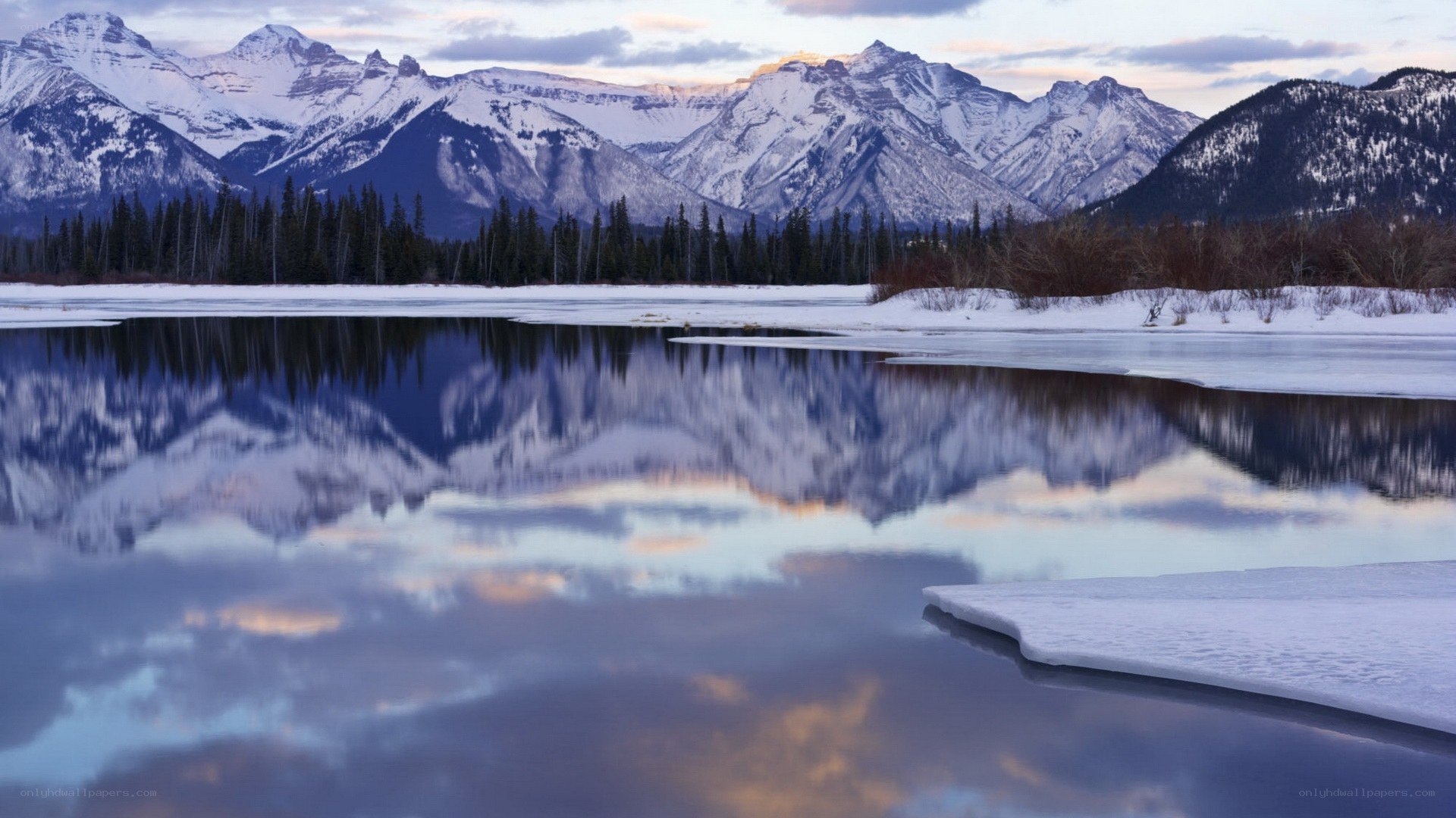 Snowy mountains reflected in a lake