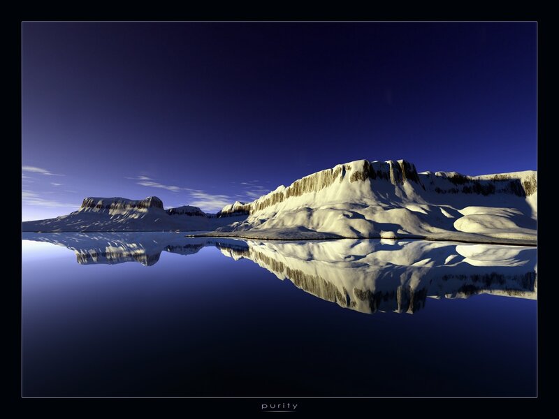 Snowy mountains reflected in calm water