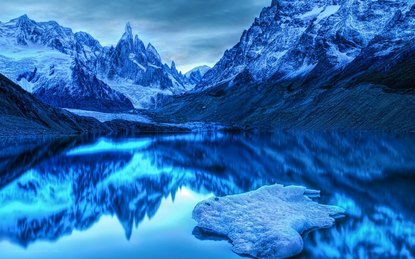 Snowy mountains reflected in lake