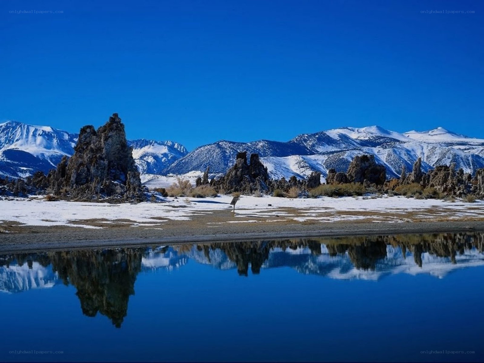 Snowy mountains reflected in lake