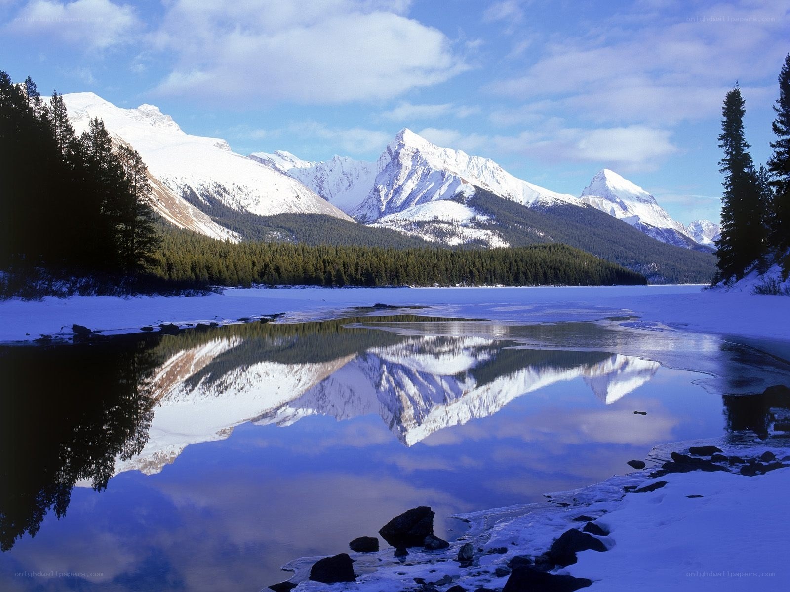 Snowy mountains reflected in lake