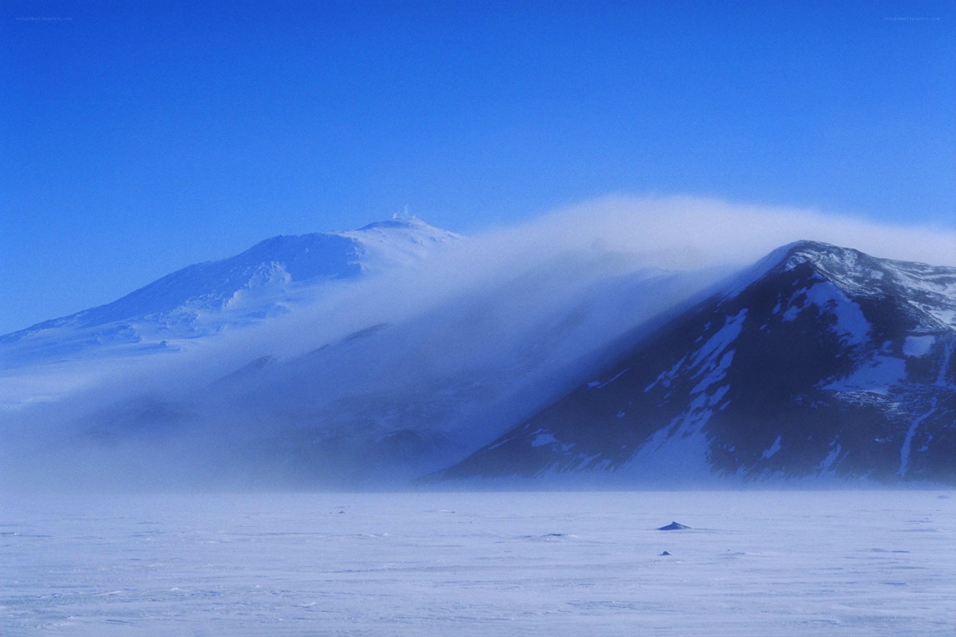 Snowy mountains under blue sky