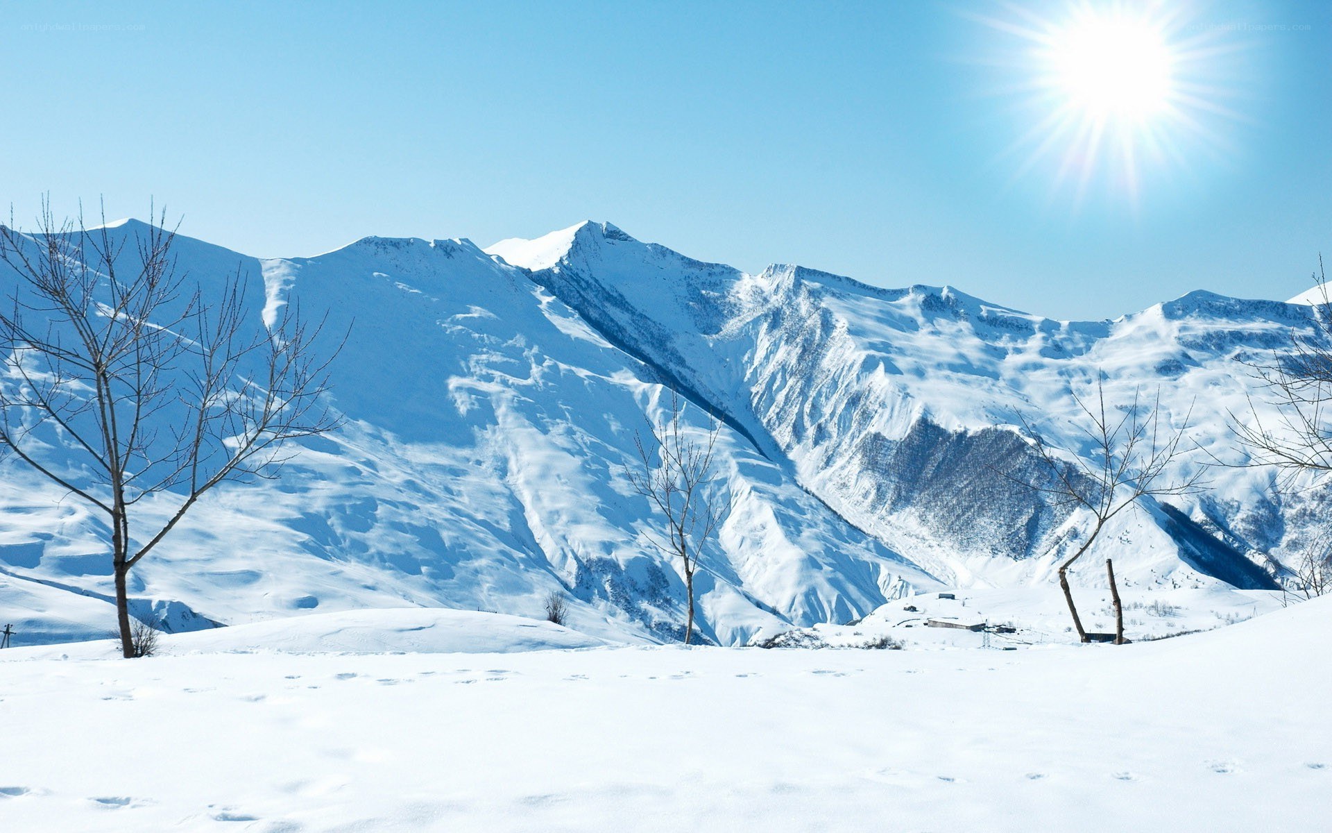 Snowy mountains under bright sun