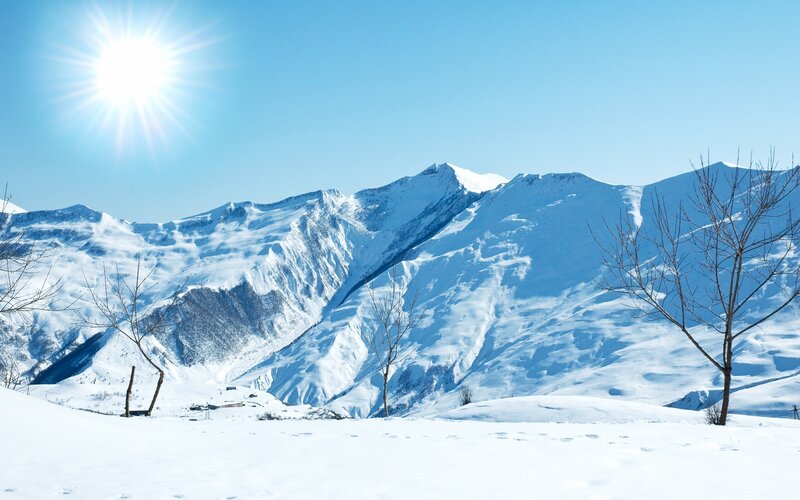 Snowy mountains under bright sun