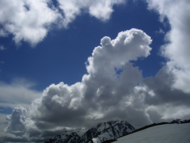 Snowy mountains under cloudy sky
