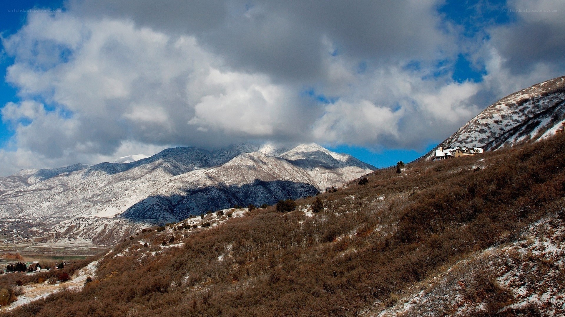 Snowy mountains under cloudy sky