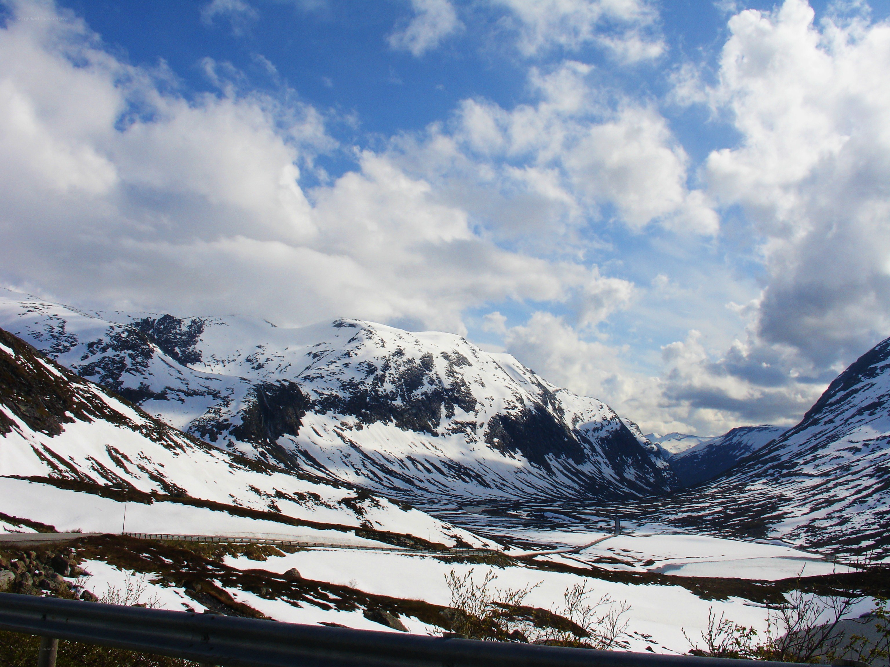 snowy mountains under cloudy sky