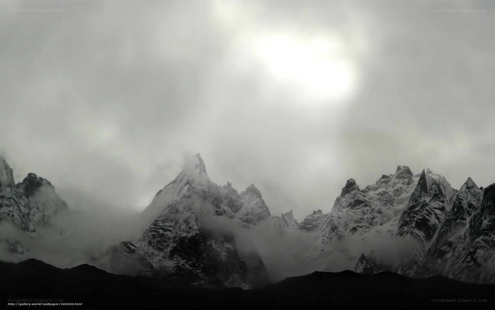 Snowy mountains under cloudy sky