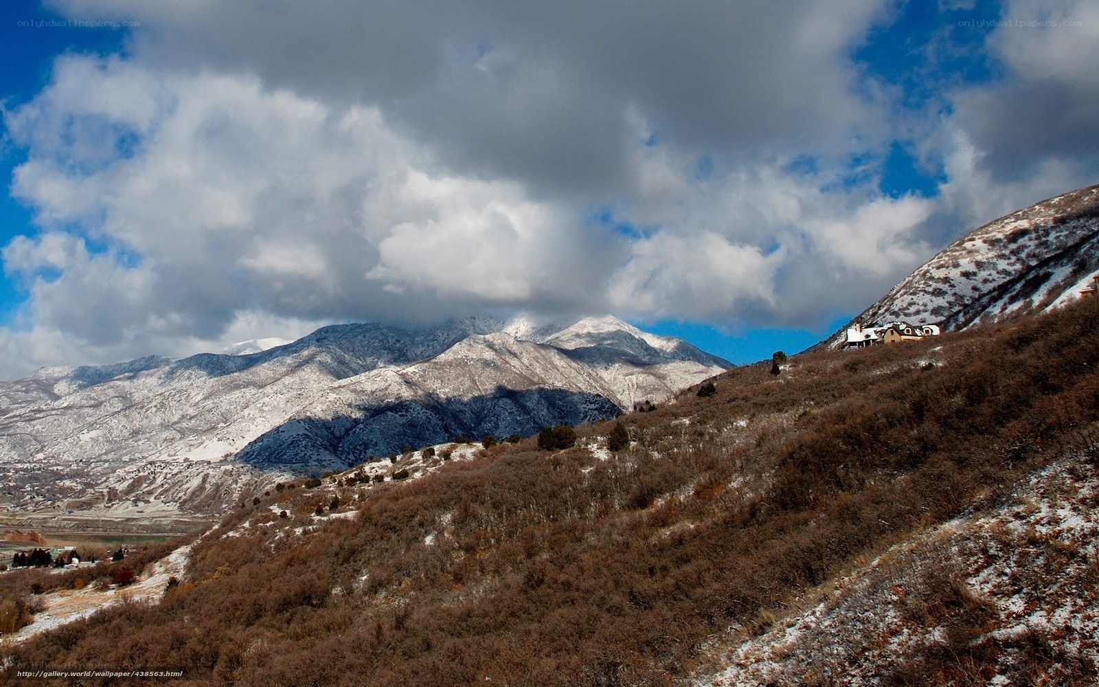 snowy mountains under cloudy sky