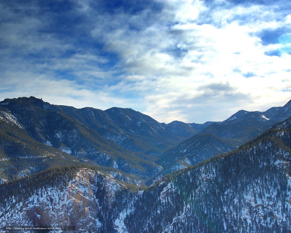 Snowy mountains under cloudy sky