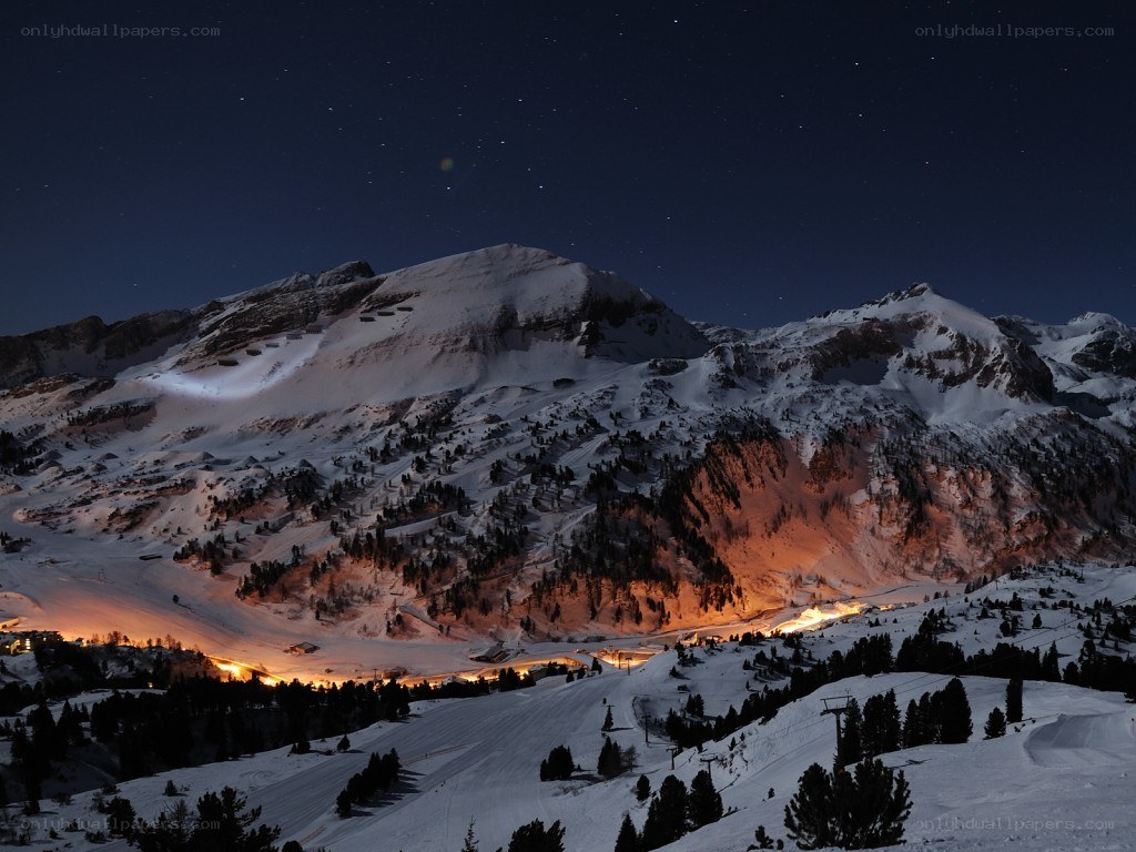 snowy mountains under starry sky
