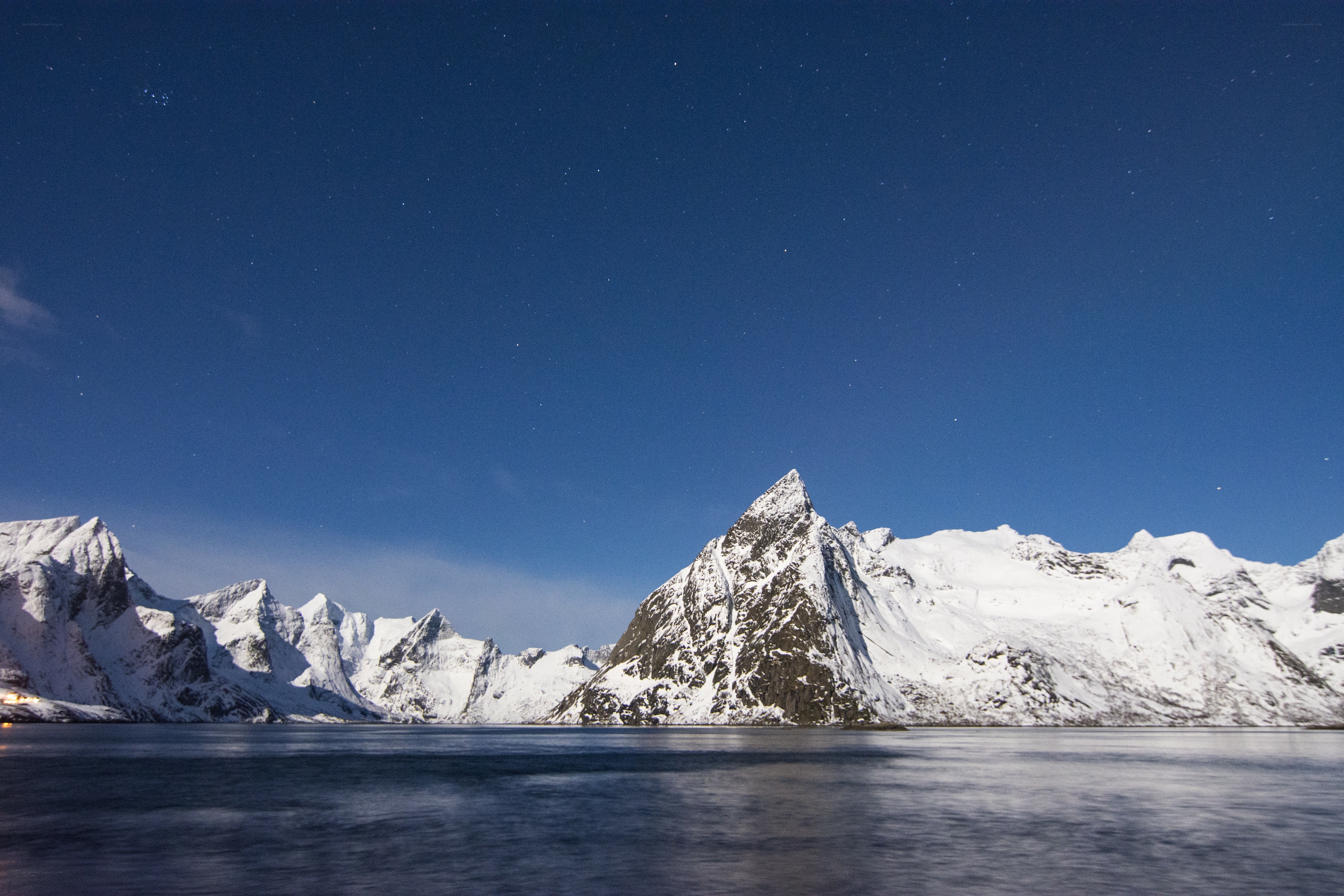 Snowy mountains under starry sky
