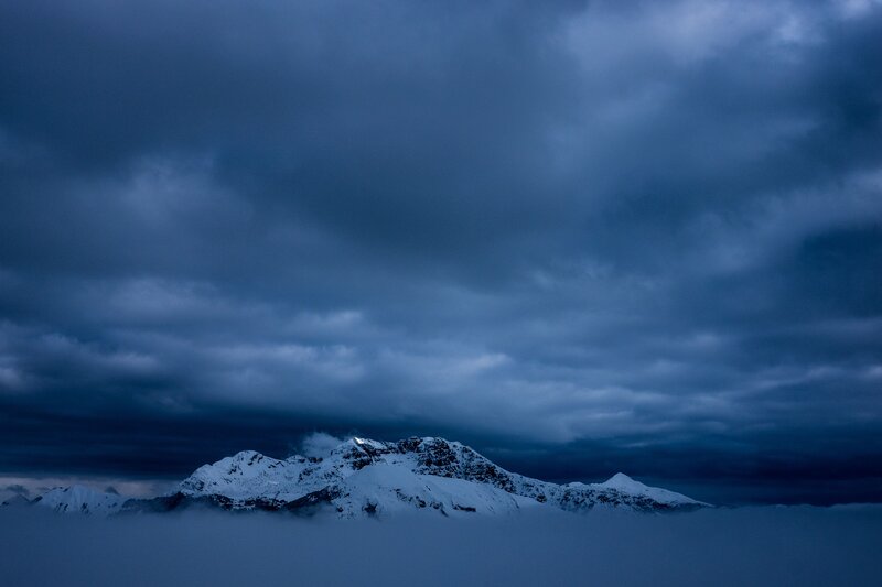 Snowy mountains under storm clouds