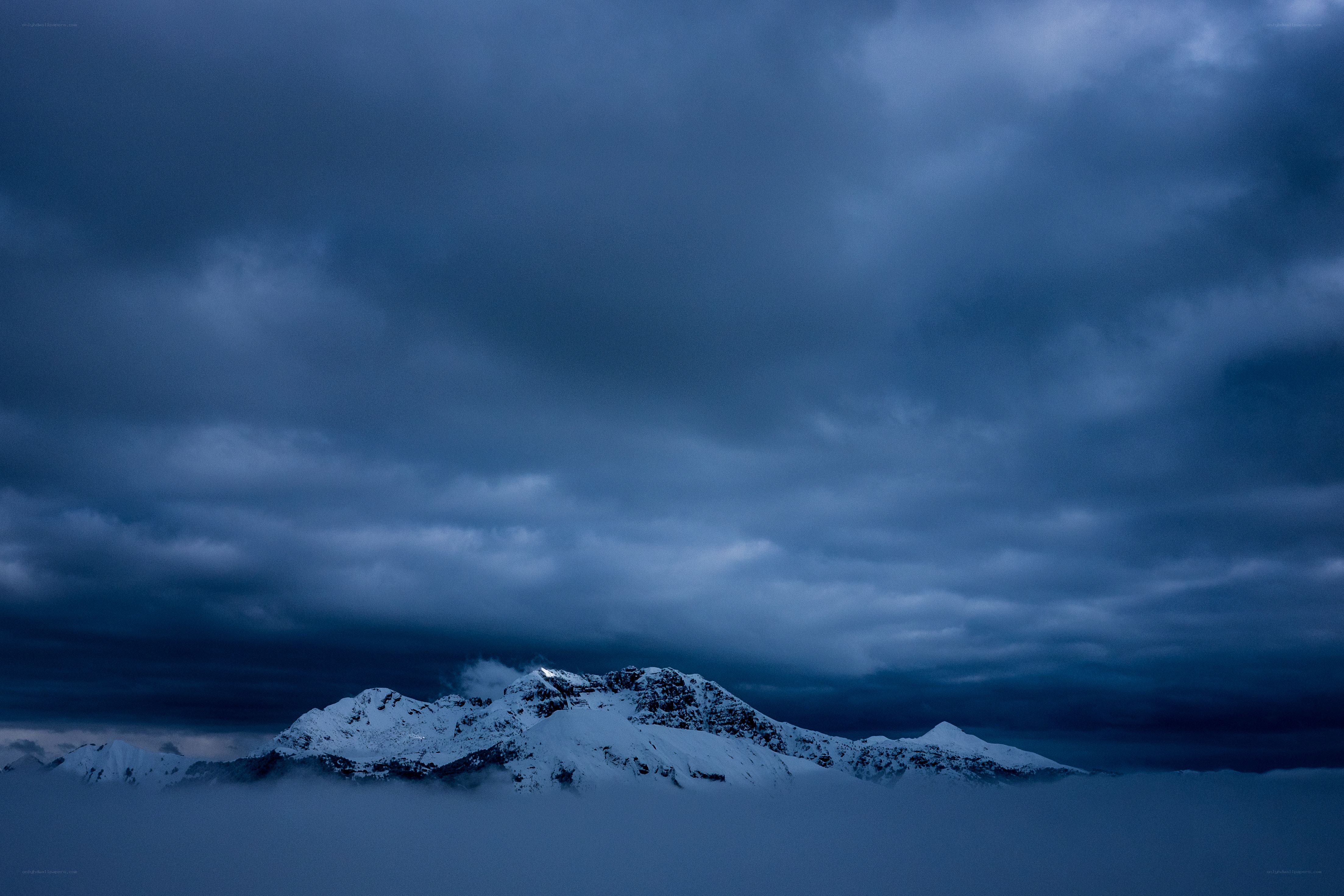 Snowy mountains under storm clouds