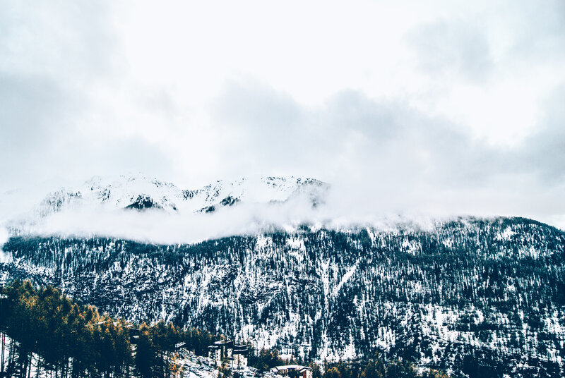 snowy mountains with clouds