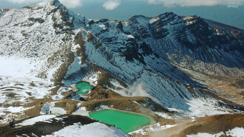 snowy mountains with green lakes