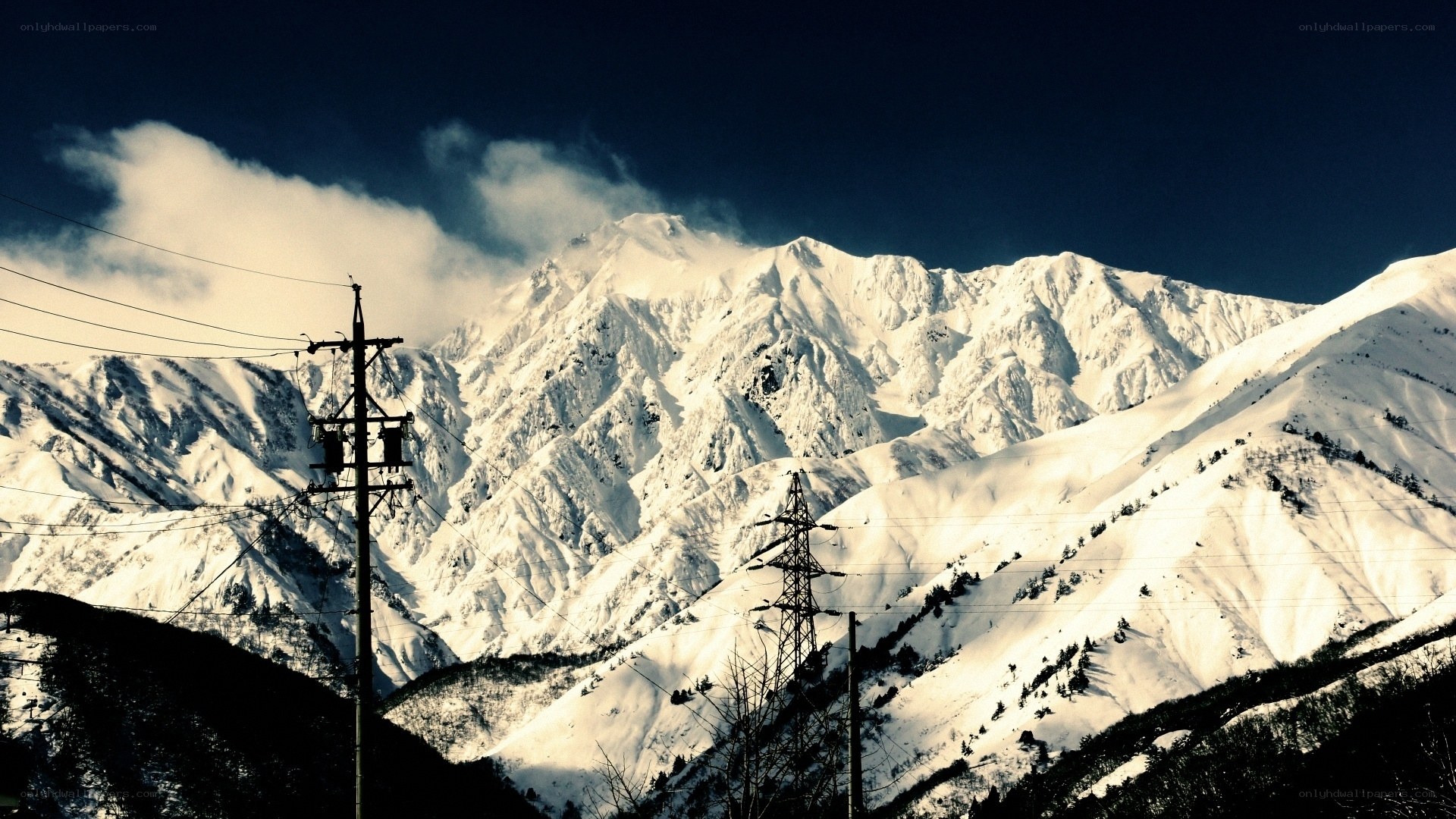 Snowy mountains with power lines