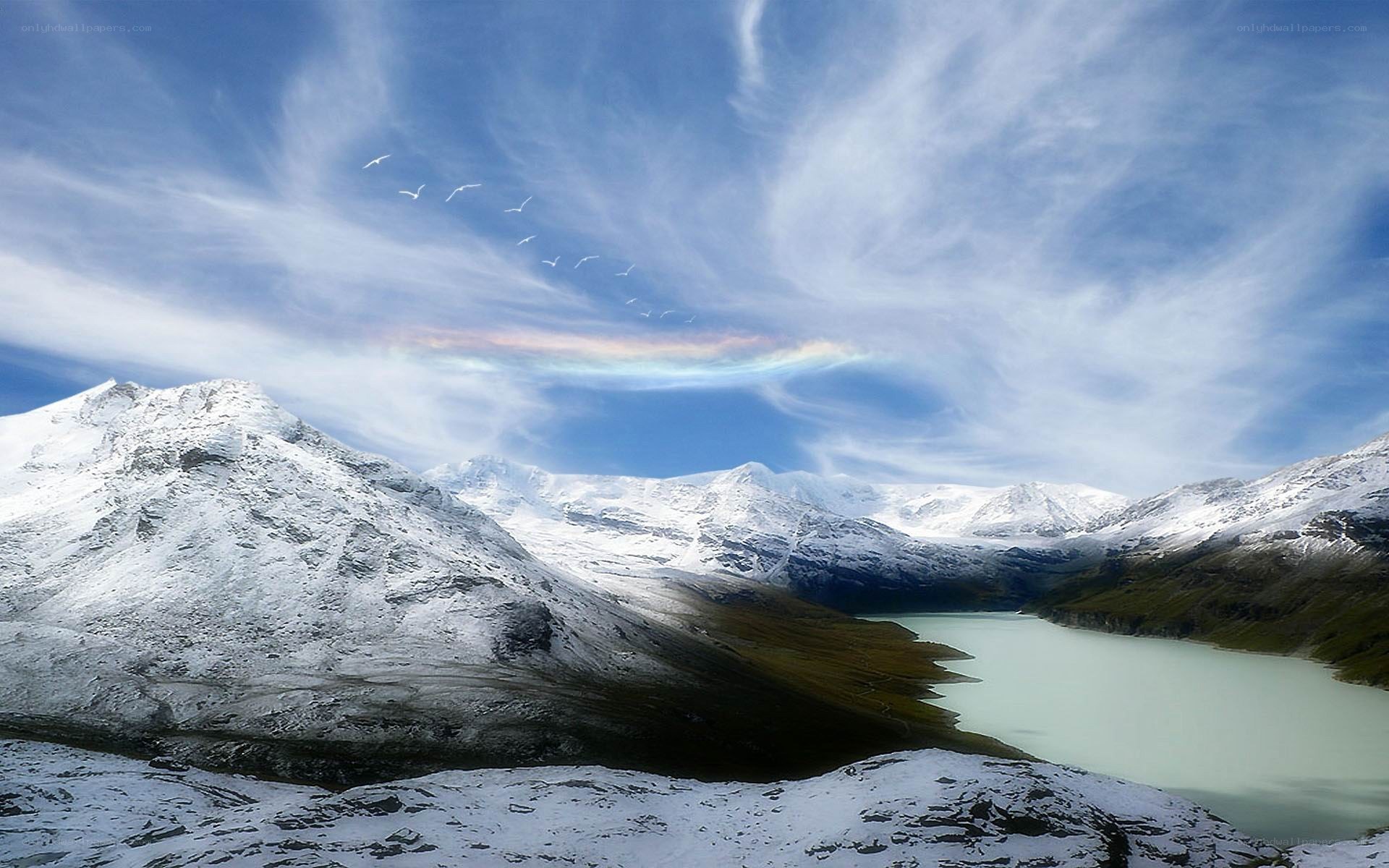 Snowy mountains with rainbow cloud