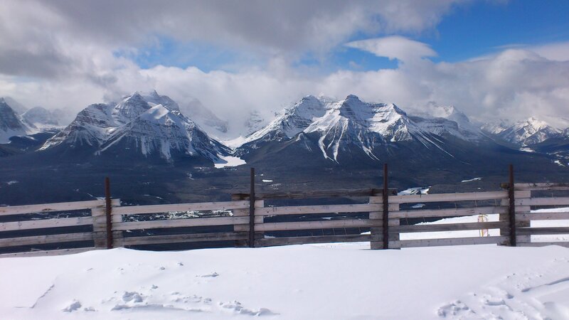 Snowy mountains with wooden fence