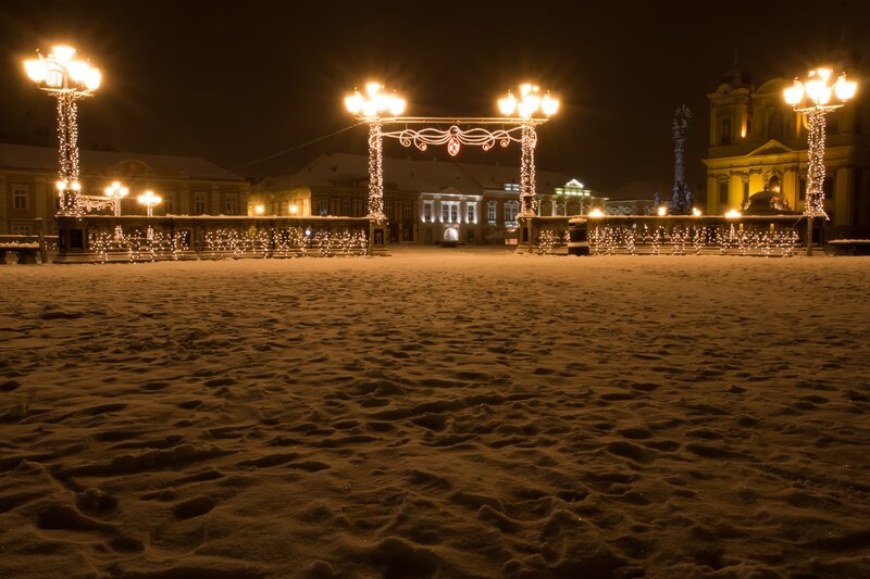 Snowy night in a decorated square