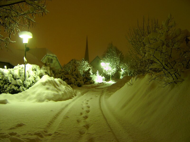 Snowy night path in a village