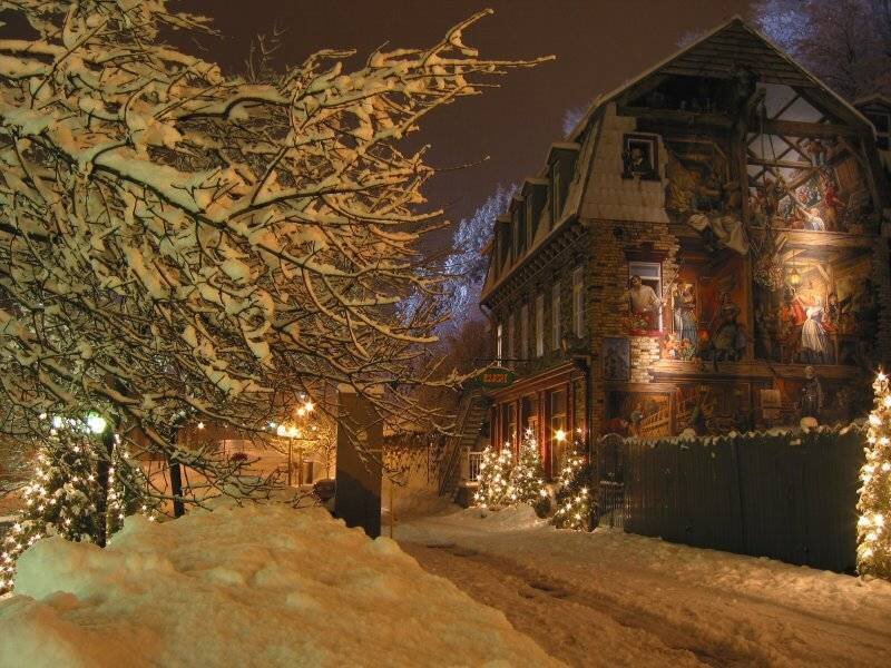 Snowy night with decorated house