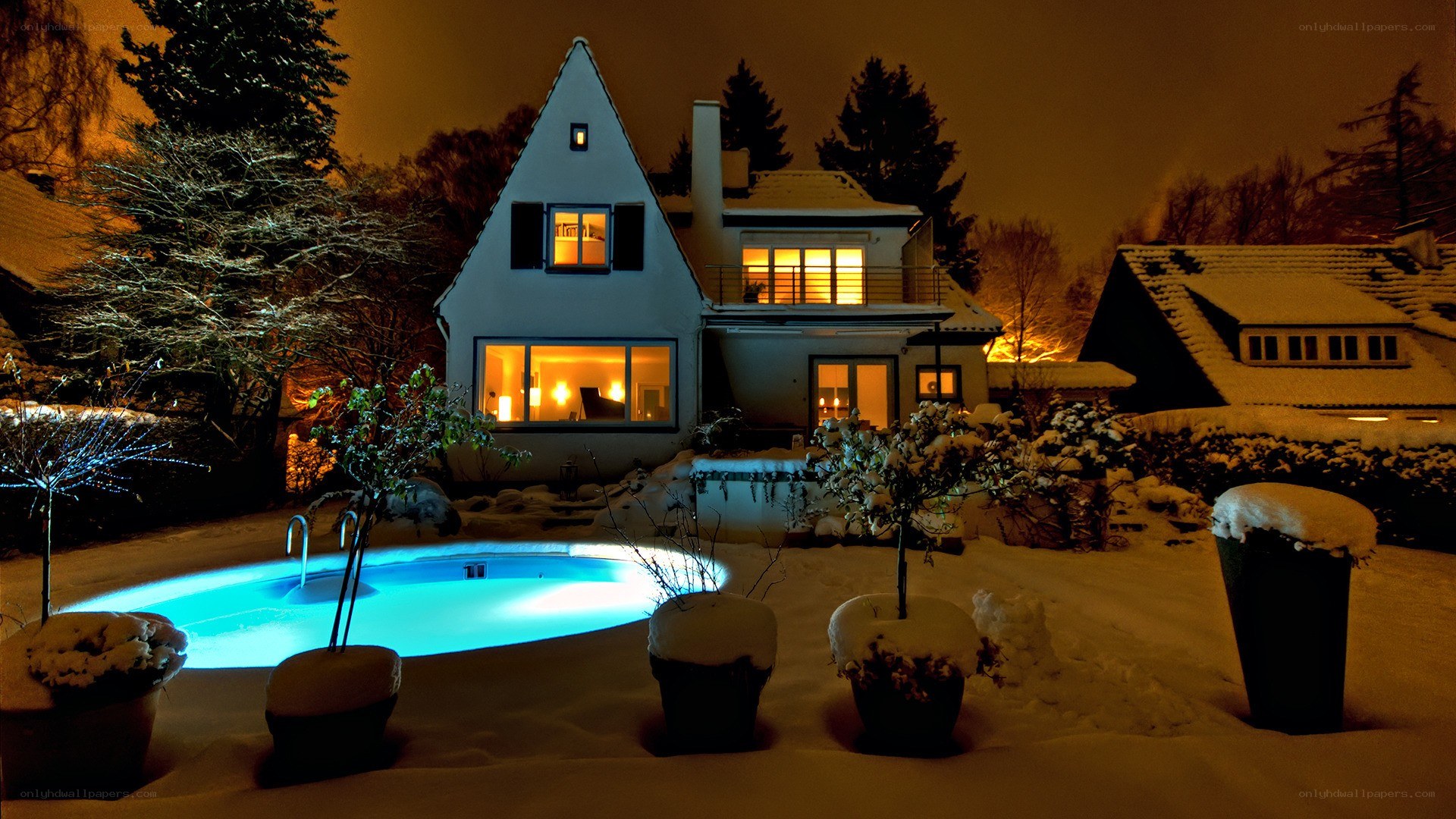Snowy night with illuminated pool