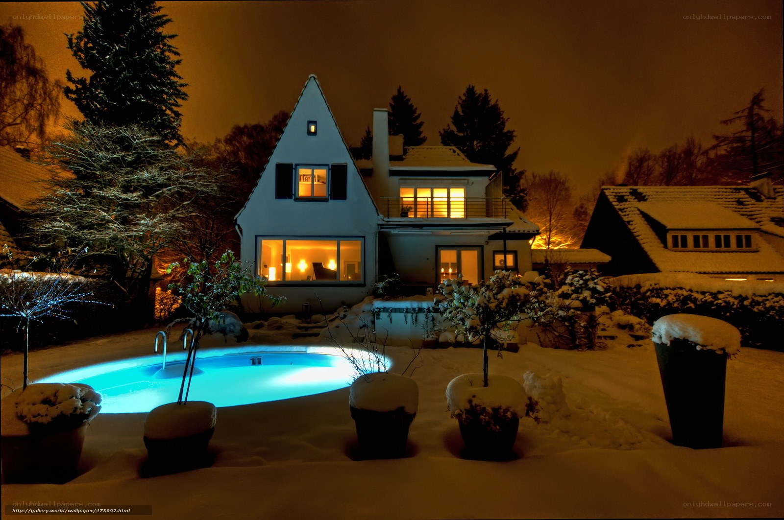 snowy night with illuminated pool