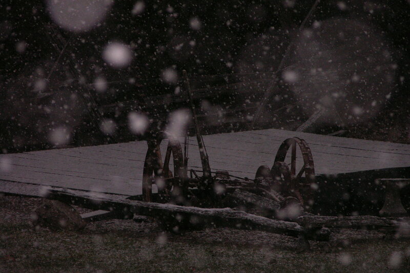 Snowy night with old machinery