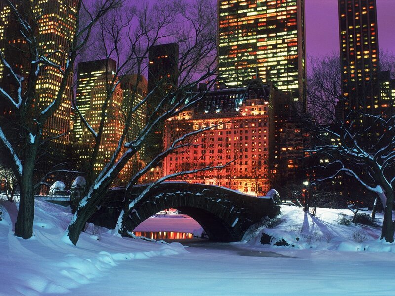 Snowy park bridge at night
