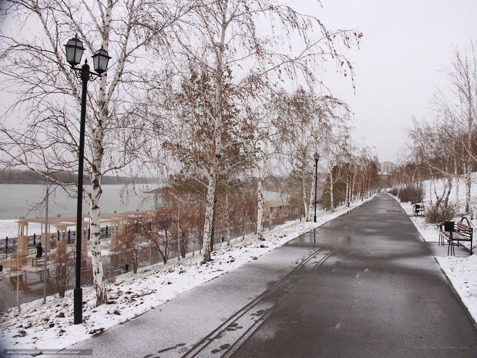 Snowy park path by the river