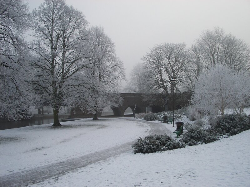 snowy park with bridge