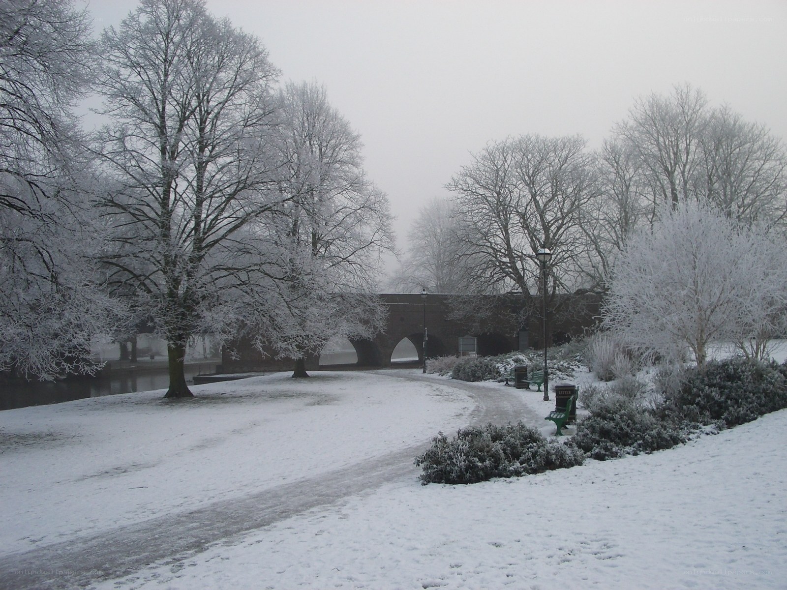 snowy park with bridge