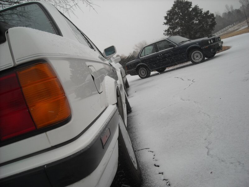 Snowy parking lot with cars