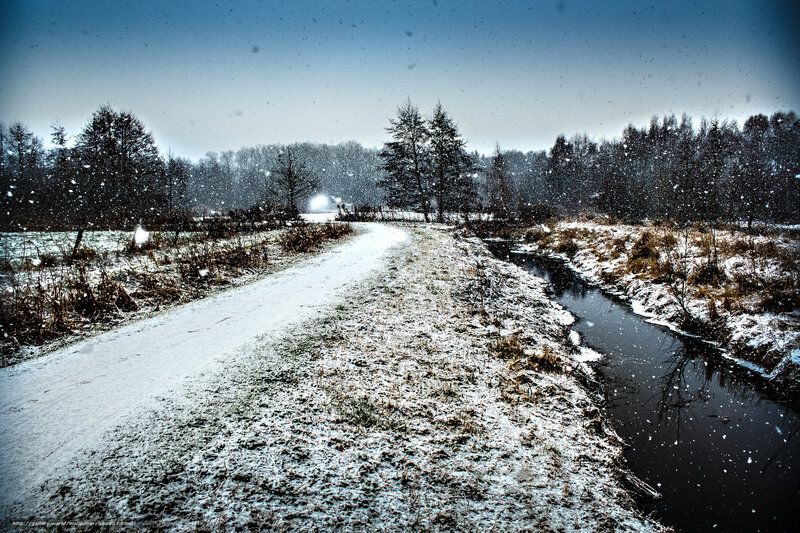 Snowy path by a stream