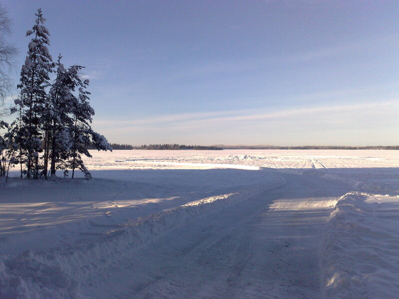 Snowy path on frozen lake