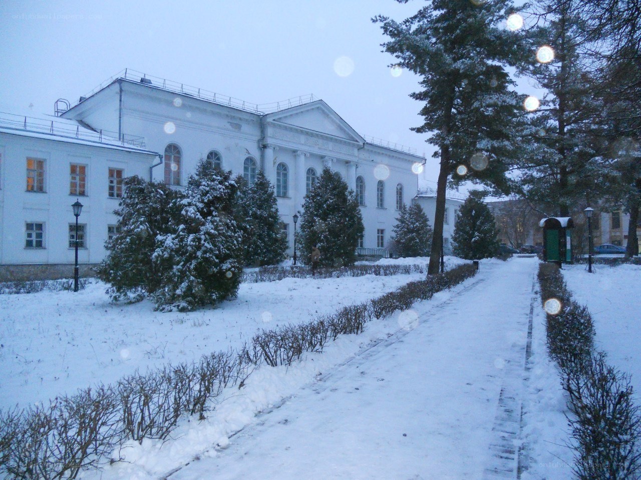 Snowy path to a white building