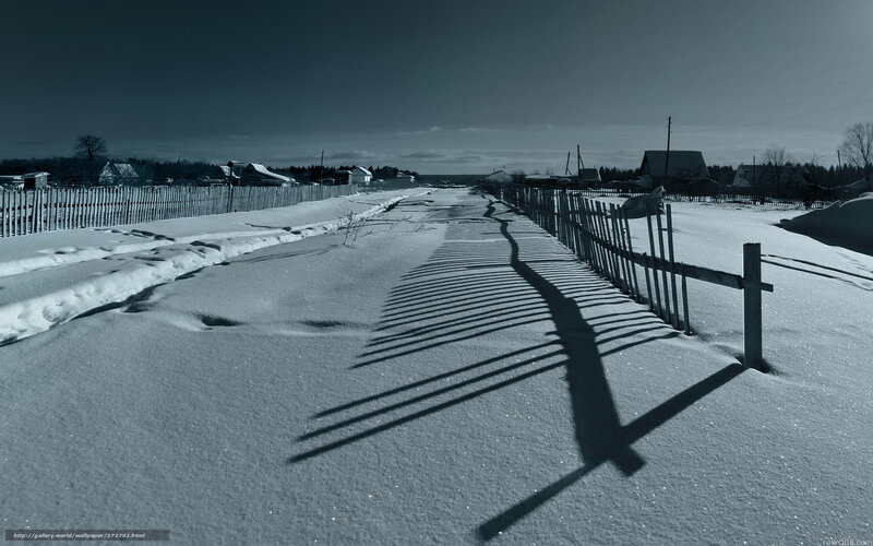Snowy path with fence shadows