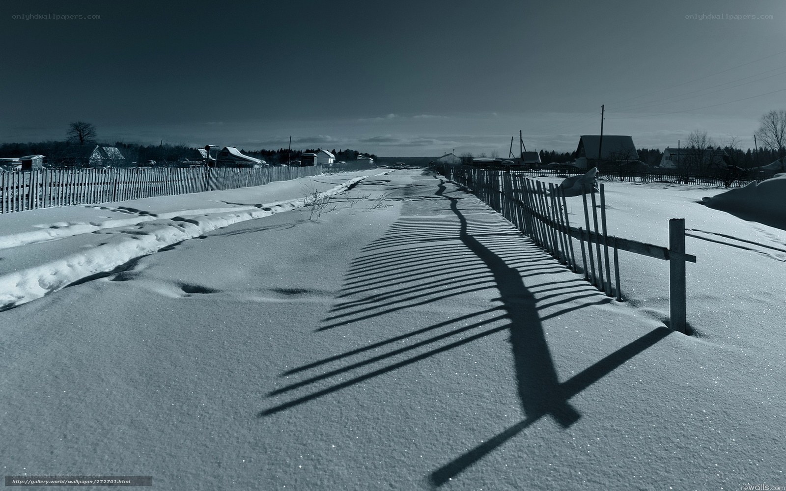 Snowy path with fence shadows