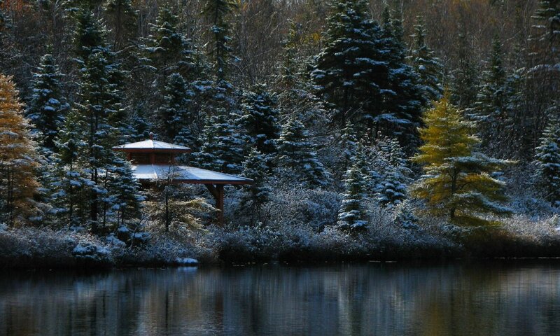 Snowy pavilion by a lake