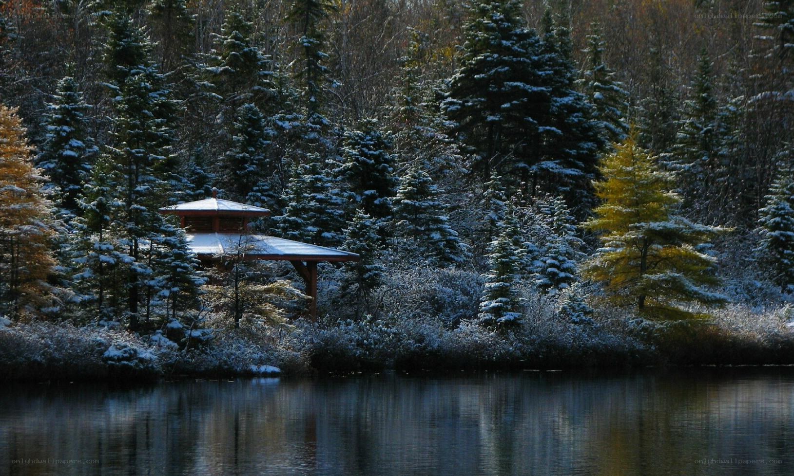 Snowy pavilion by a lake