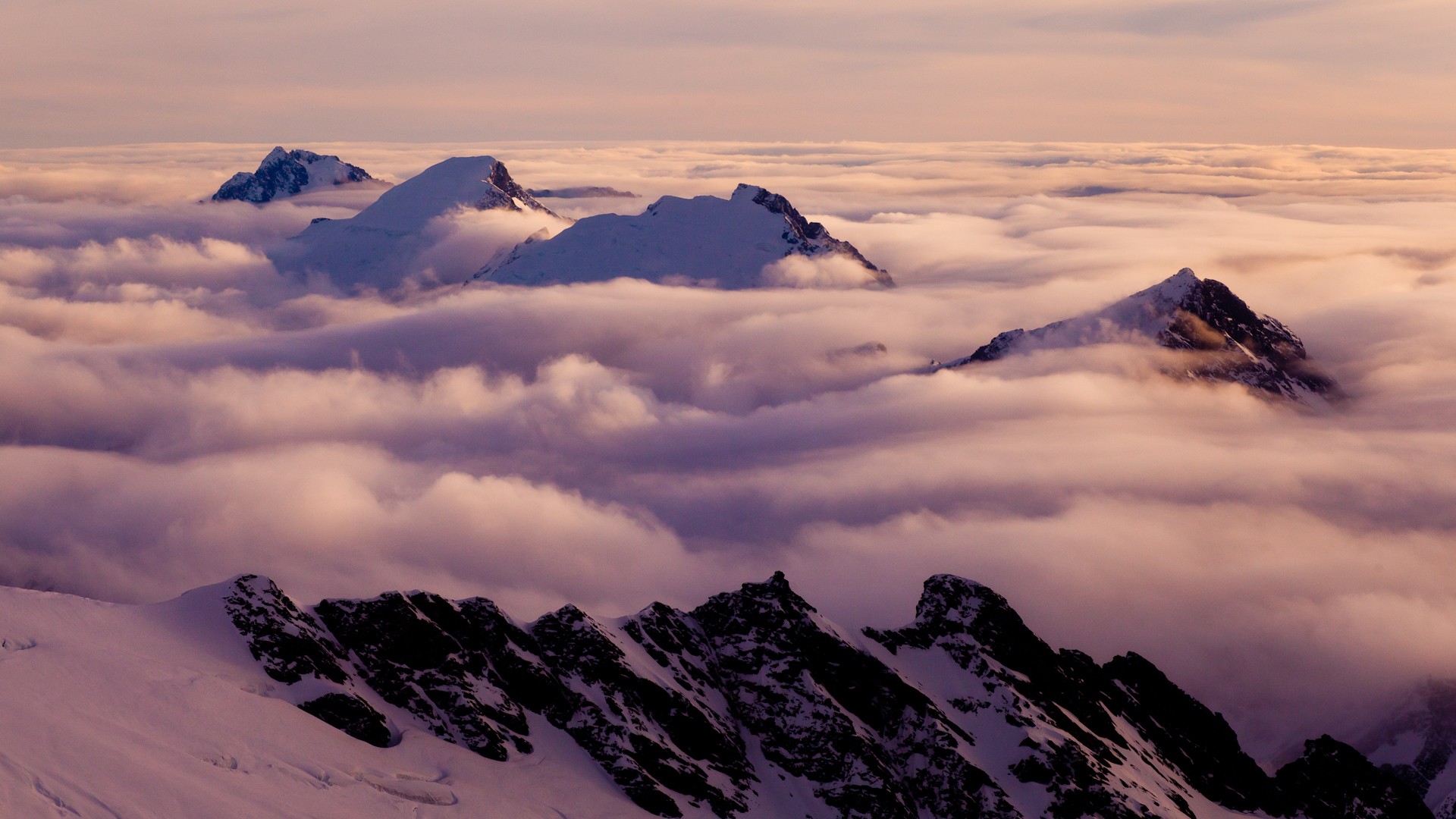 Snowy peaks above clouds
