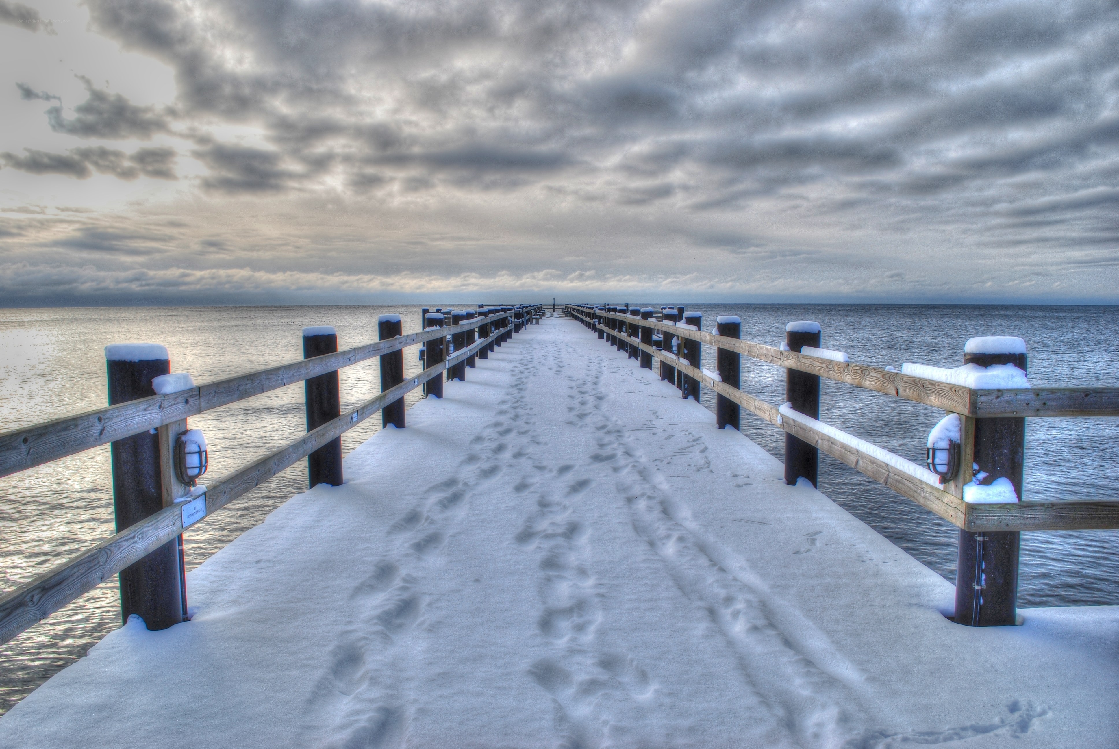 Snowy pier at dusk